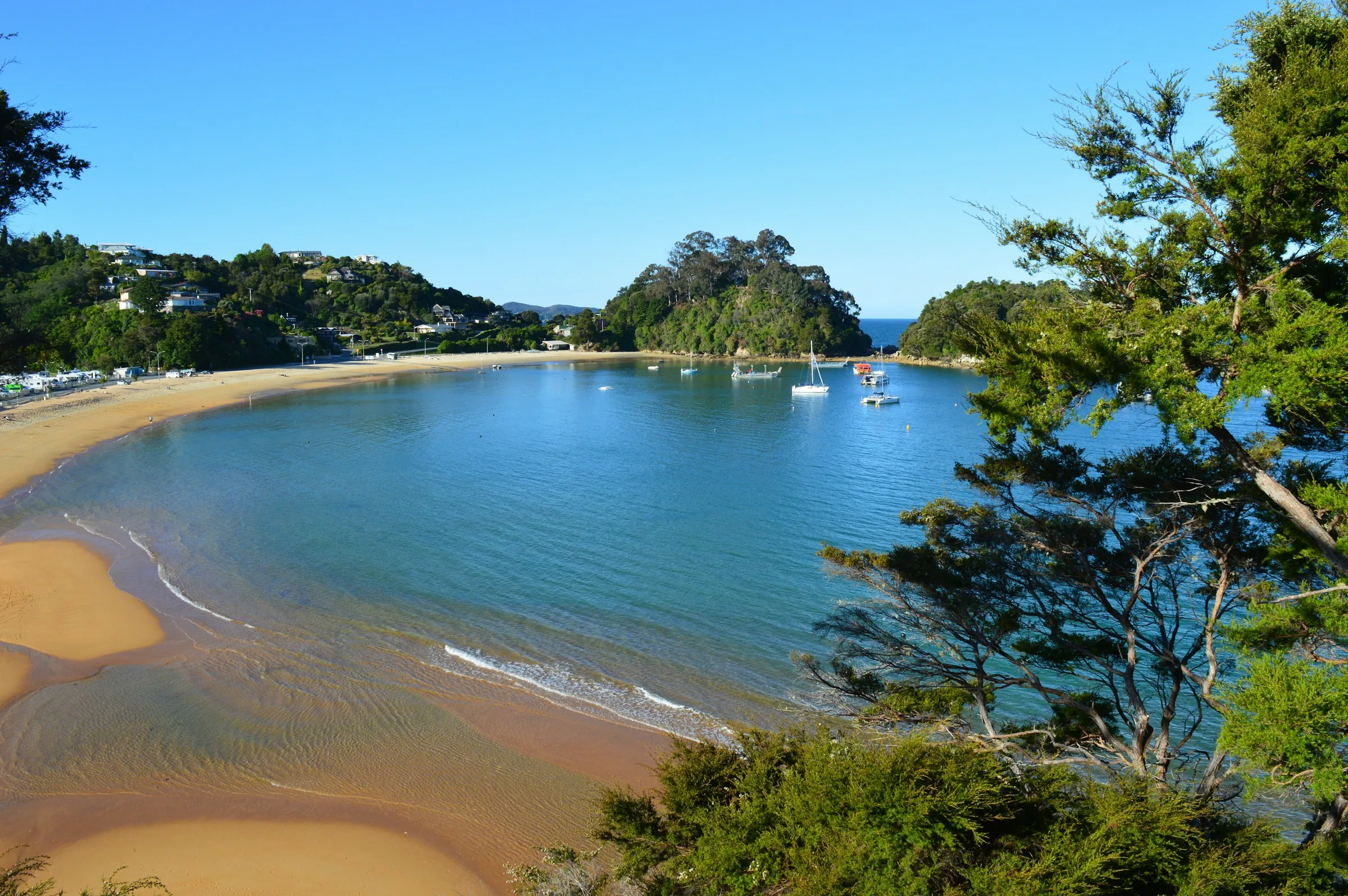 Golden Abel Tasman beach with boats and clear coastal water